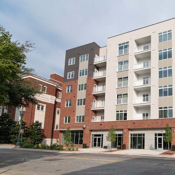 A large multi-story building with a combination of brick and white exterior walls.
