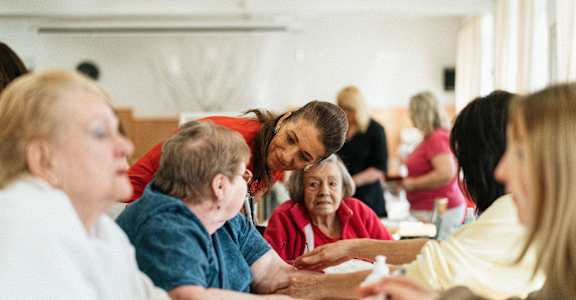 A group of people sitting around a table in a room.