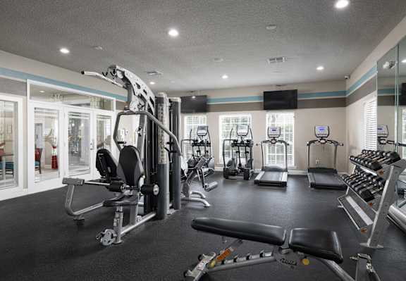 A well-equipped gym with a variety of machines and weightlifting equipment.