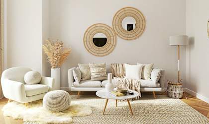 a living room with a couch and mirrors on the wall