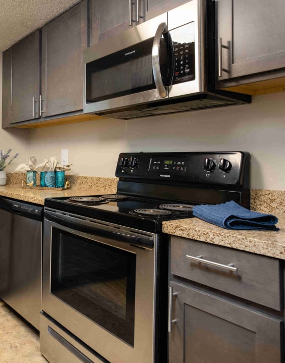 full kitchen with stainless steel appliances and granite counter tops