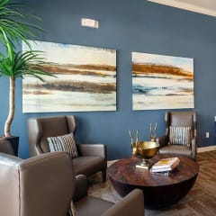 a living room with blue walls and chairs and a table