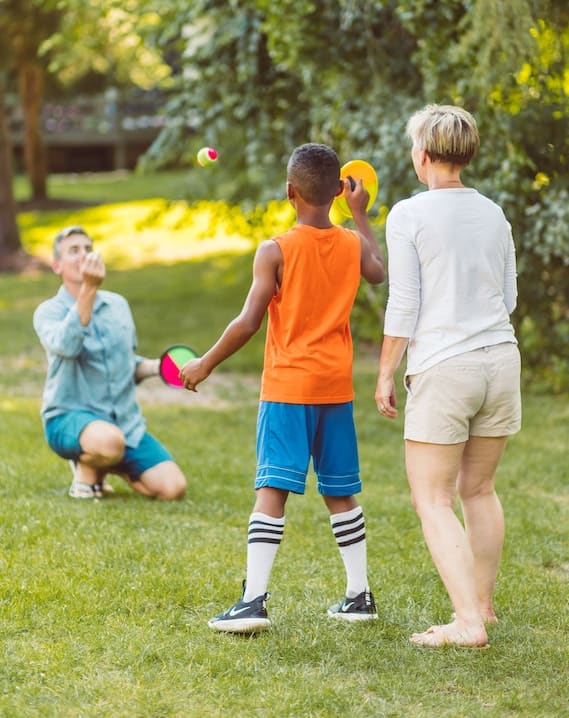 a group of children playing with balls in a park