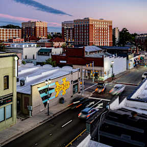 A city street with cars and buildings.