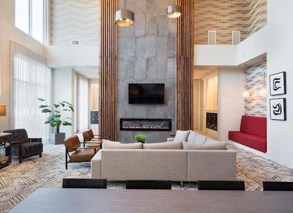 a living room with couches and chairs and a fireplace