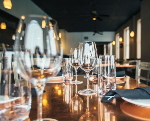 a table set for a meal with wine glasses and napkins