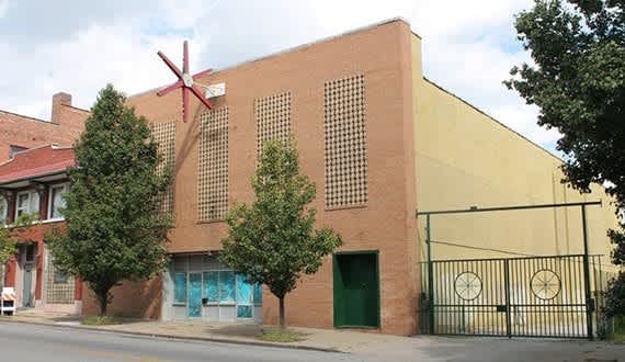 a building with a windmill on the side of it