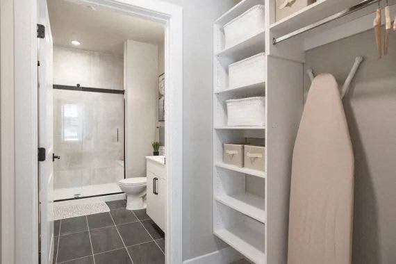 A white bathroom with a toilet and a shower. at Coda at Bryant Street, Washington, DC 20002