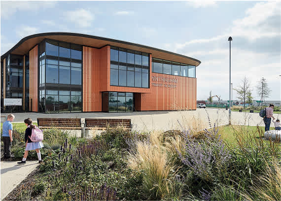 A modern building with a curved facade and large windows.at Penny Green Apartments