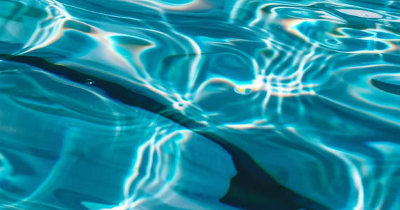 The image shows a close-up of water with light reflecting off of it.