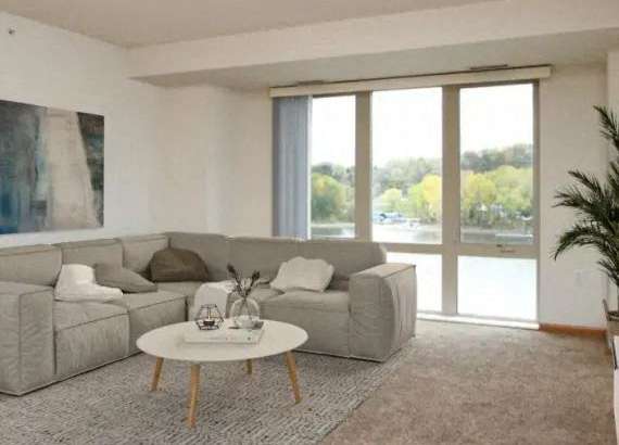 Living Room with a Large Window at Joseph's Pointe at Upper Landing Apartments, St. Paul, MN, 55102