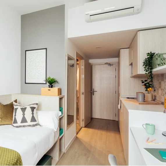 a bedroom and a kitchen in a small apartment