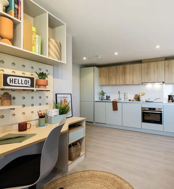 a kitchen and a desk in a room