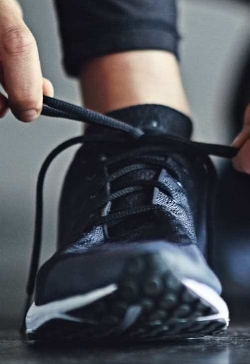Person lacing running shoes at Park Avenue Apartments, San Jose, CA 95126
