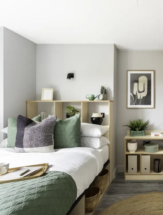 a small bedroom with a bed and a desk with a chair