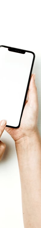 A person holding a smartphone with a blank screen.