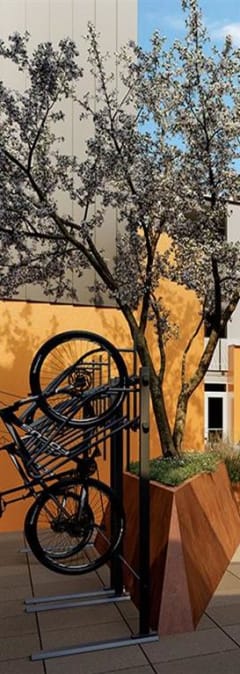 a rendering of a building with a person riding a bike in front of it