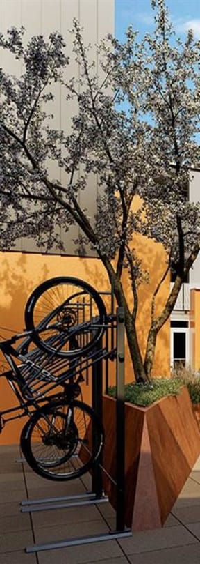 a rendering of a building with a person riding a bike in front of it
