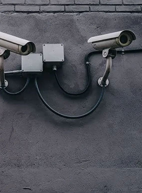 a pair of security cameras on a wall