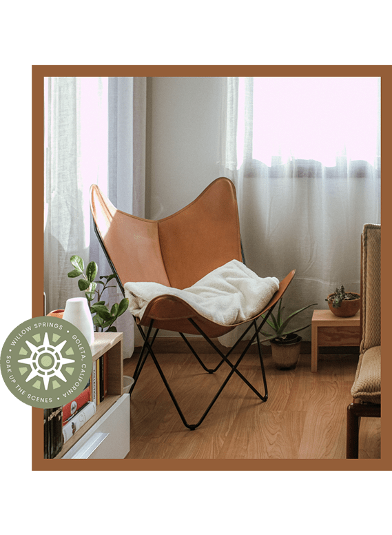 a chair with a blanket on it in a living room
