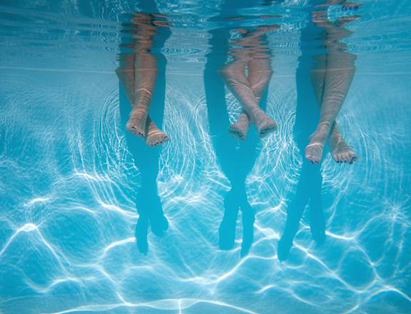 a group of people standing in a swimming pool