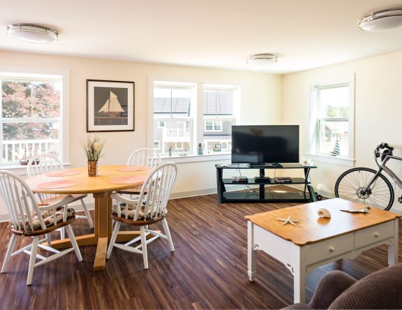 a living room with a table and chairs and a television