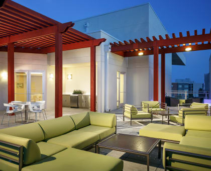 a patio with couches and chairs at night