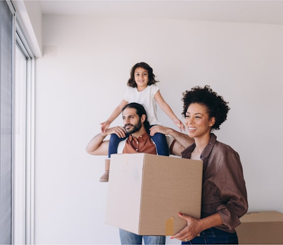 a group of people moving into a house with a box