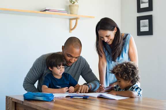 Parents helping kids with homework at Cobia Cove Apartments, Holiday