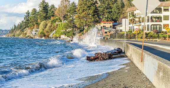 A beach scene with waves crashing onto the shore.