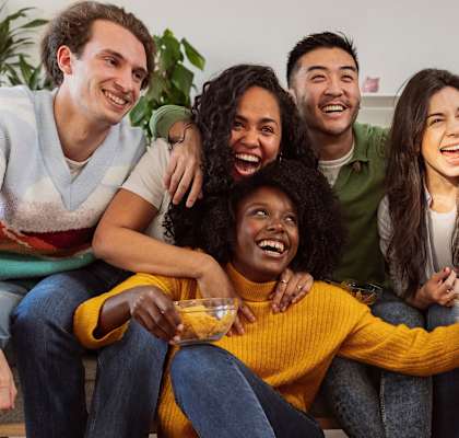 a group of people sitting on a couch with a dog