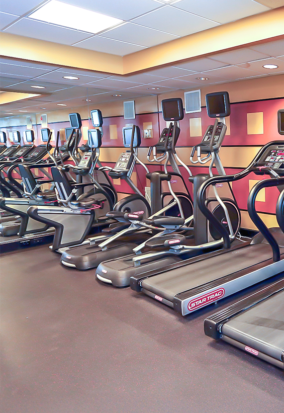 A gym with treadmills and exercise equipment.