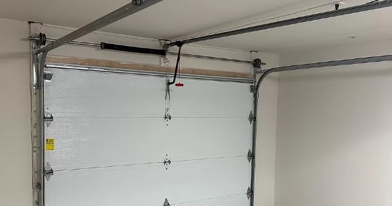 the garage door is white and the ceiling is white