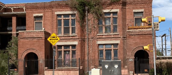 an old brick building on the corner of a street