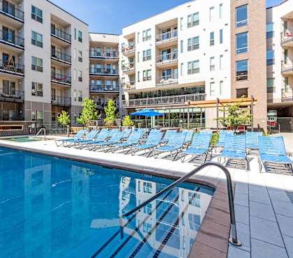 A swimming pool in front of apartment buildings at Regatta Sloans Lake Apartments, Colorado, 80204