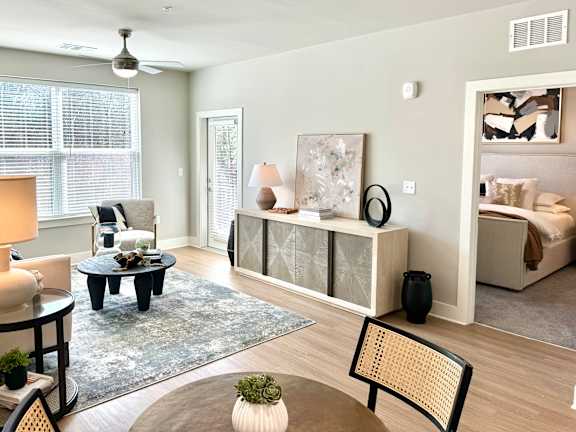 A billiard table is in the middle of a room with a television and a pool table at The Collective Upper Westside Apartments, Atlanta, GA, 30318
