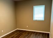 Thumbnail 44 of 48 - A room with a window and a wooden wall.