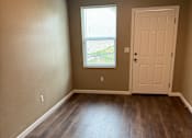 Thumbnail 41 of 48 - A room with a window and a wooden wall.
