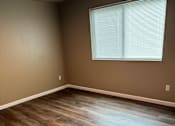 Thumbnail 26 of 48 - A room with a skylight and wooden flooring.