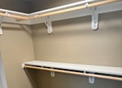 Thumbnail 27 of 48 - A white ladder with wooden handles is leaning against a wall.