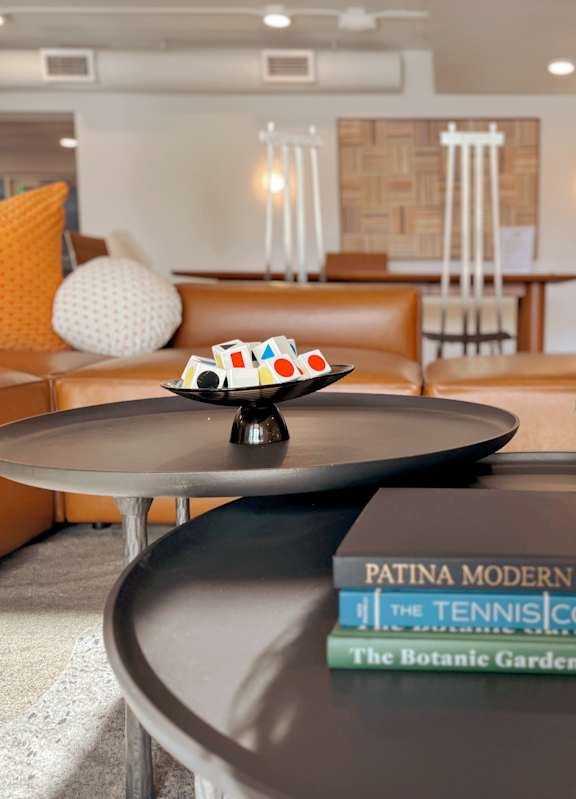 A living room with a round table, a couch, and a potted plant. at The Teale Siesta Lago in Kissimmee, FL, 34746