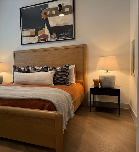 A person is sitting by a pool using a laptop.