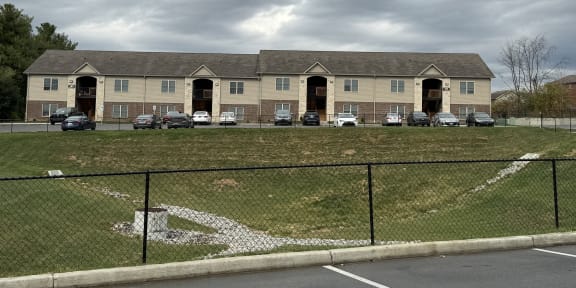 a large building with cars parked in front of it