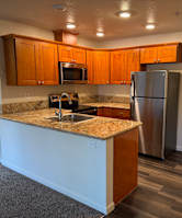 A room with carpeted floor and three doors.