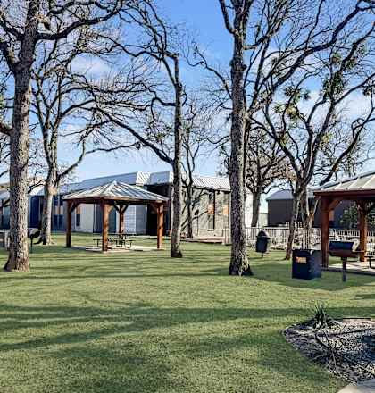 A park with a gazebo and picnic tables.
