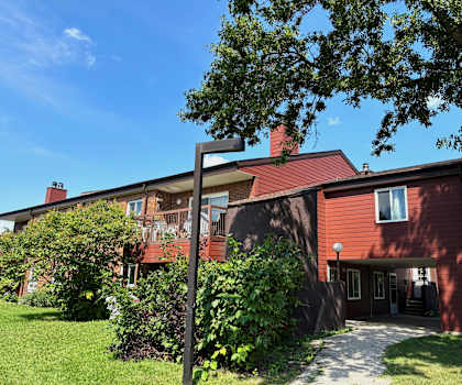 A red house with a white door and windows.