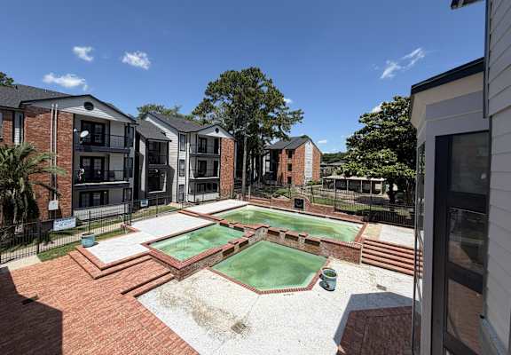 A backyard with a pool table and a basketball hoop.