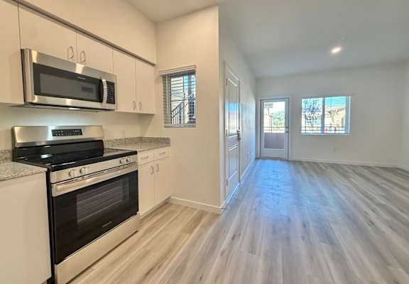 A kitchen with a stove, oven, and cabinets.