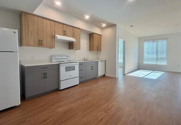 A kitchen with wooden cabinets and a white refrigerator.