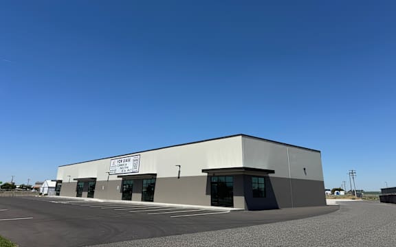 A large industrial building with a sign that reads "Fossil" on the front.